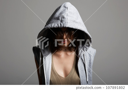 young woman in hood. sexy girl in grey hoodie 107891802
