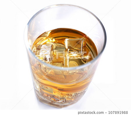 Whiskey with ice in a glass isolated Whiskey with ice in a glass isolated 107891988