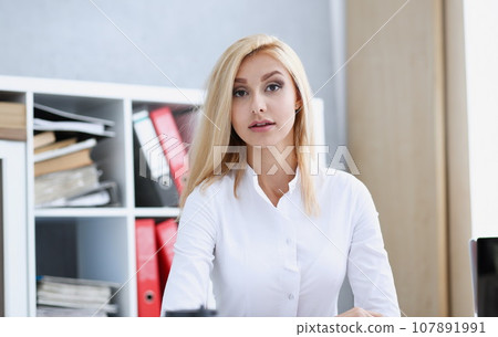 Beautiful smiling businesswoman portrait at workplace Beautiful smiling businesswoman portrait at workplace 107891991