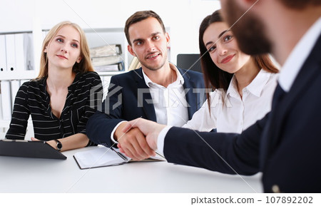 Smiling man in suit shake hands as hello 107892202
