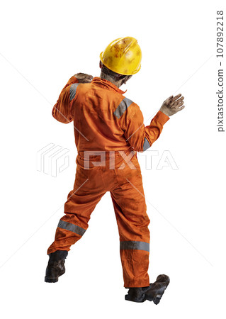 A scary construction worker zombie with blood and wounds on his body walking while carrying a pipe wrench A scary construction worker zombie with blood and wounds on his body walking while carrying a pipe wrench 107892218