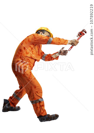 A scary construction worker zombie with blood and wounds on his body walking while carrying a pipe wrench A scary construction worker zombie with blood and wounds on his body walking while carrying a pipe wrench 107892219