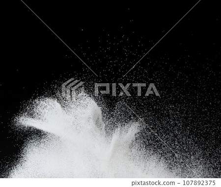 Million of white sand explosion, Photo image of falling down shower snow, heavy snows storm flying. Freeze shot on black background isolated overlay. Tiny Fine Salt sands as particle science 107892375