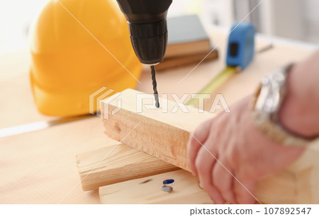 Arms of worker using electric drill Arms of worker using electric drill 107892547