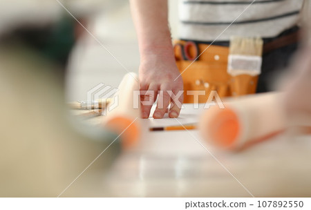 Arms of worker making structure plan 107892550