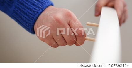 Male arms assembling furniture closeup 107892564