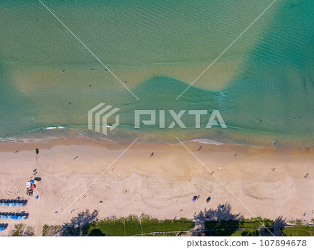 Summer sea nature background,Aerial view of Waves crashing on sandy shore,Sea surface ocean waves background,Top view beach background 107894678
