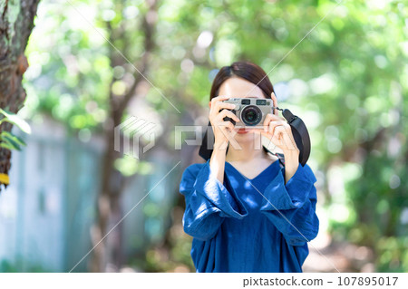 A woman taking a picture A woman taking a picture 107895017