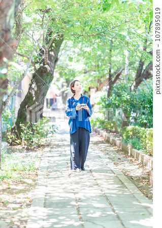 A woman holding a camera A woman holding a camera 107895019