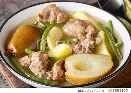 Mutton ragout with Pears, Potatoes, Onions and Green Beans closeup on the plate. Horizontal Mutton ragout with Pears, Potatoes, Onions and Green Beans closeup on the plate. Horizontal 107895115