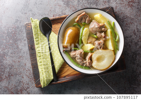 Swedish Lamb stew with fresh pears, potatoes, green beans close-up in a bowl. horizontal top view Swedish Lamb stew with fresh pears, potatoes, green beans close-up in a bowl. horizontal top view 107895117