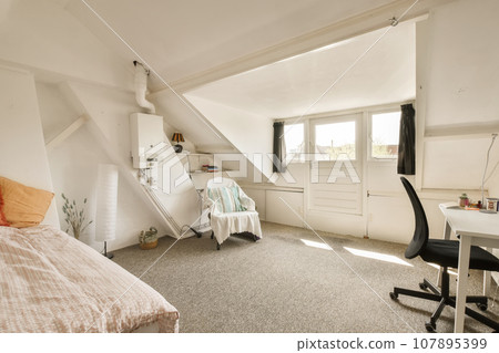 a bedroom with a bed, desk and computer on the floor in front of an attic style room that has been used for storage a bedroom with a bed, desk and computer on the floor in front of an attic style room that has been used for storage 107895399