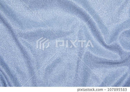 Background of draped light blue fabric with silver lurex thread Background of draped light blue fabric with silver lurex thread 107895583