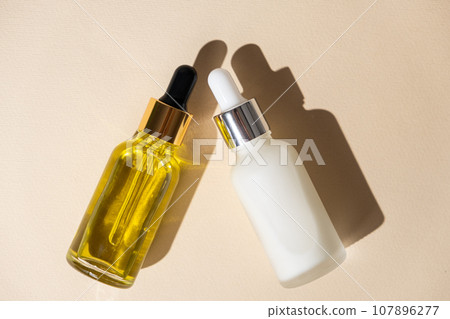 Natural cosmetics in glass jars with a pipette dispenser - oil and cream for skin and hair care 107896277