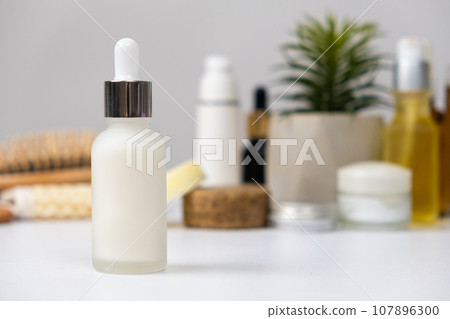 Natural herbal eco cosmetics - cream or serum in a glass jar with a pipette dispenser 107896300