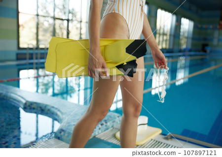 Cropped shot of sportive female swimmer legs closeup Cropped shot of sportive female swimmer legs closeup 107897121