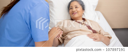 Doctor woman encourage with elderly patient at the hospital, physician or nurse take care. Doctor woman encourage with elderly patient at the hospital, physician or nurse take care. 107897191