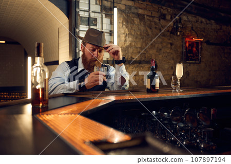 Portrait of mature gentleman drinking in bar Portrait of mature gentleman drinking in bar 107897194