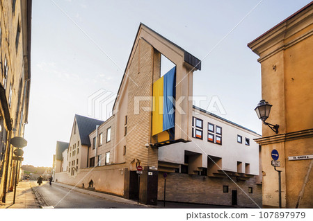 Vilnius, Lithuania - 13 06 2023 Ignoto street, an unusual building with a large Ukrainian flag 107897979