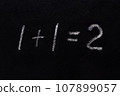 Simple math equation 1 1 2 written school board chalk. Blackboard equations one plus one equals two written black board background. 1 plus 1 equals 2 writing chalkboard background. Elementary school 107899057