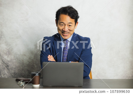 Businessman, middle-aged man, using a computer 107899630