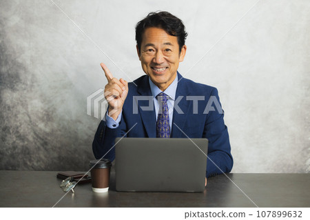 Businessman, middle-aged man, using a computer Businessman, middle-aged man, using a computer 107899632