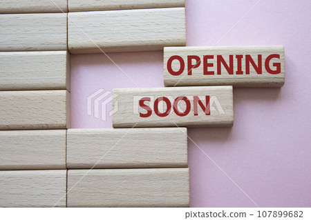 Opening soon symbol. Concept word Opening soon on wooden blocks. Beautiful pink background. Business and Opening soon concept. Copy space Opening soon symbol. Concept word Opening soon on wooden blocks. Beautiful pink background. Business and Opening soon concept. Copy space 107899682