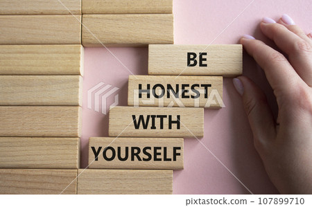Be honest with Yourself symbol. Wooden blocks with words Be honest with Yourself. Businessman hand. Beautiful pink background. Be honest with Yourself concept. Copy space. 107899710