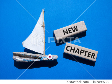 New Chapter symbol. Concept word New Chapter on wooden blocks. Beautiful blue background with boat. Business and New Chapter concept. Copy space 107899729