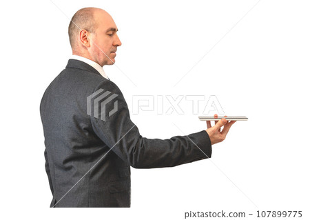 serious man with a tablet. businessman holding touchpad serious man with a tablet. businessman holding touchpad 107899775