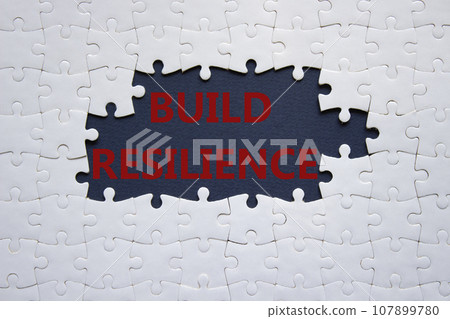 Build resilience symbol. White puzzle with words Build resilience. Beautiful dark blue background. Business and Build resilience concept. Copy space. Build resilience symbol. White puzzle with words Build resilience. Beautiful dark blue background. Business and Build resilience concept. Copy space. 107899780