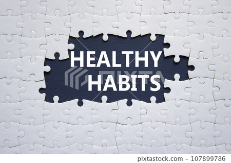 Healthy habits symbol. Concept word Healthy habits on white puzzle blocks. Beautiful dark blue background. Business and Healthy habits concept. Copy space Healthy habits symbol. Concept word Healthy habits on white puzzle blocks. Beautiful dark blue background. Business and Healthy habits concept. Copy space 107899786