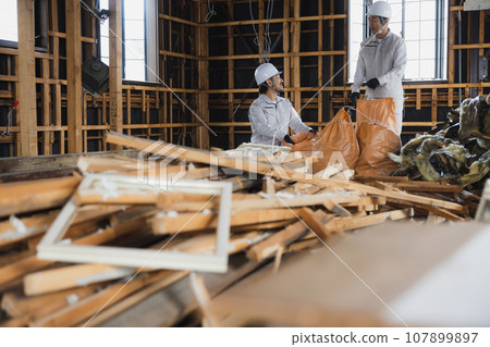 Workers working at a demolition site 107899897