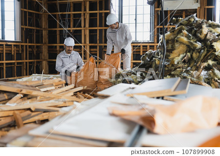 Workers working at a demolition site 107899908