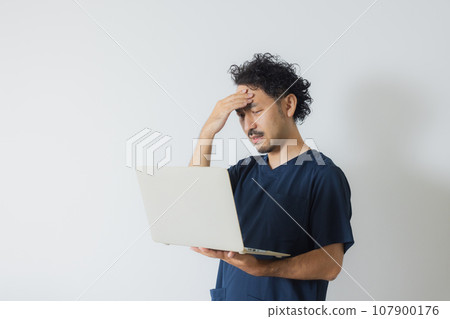 Doctor with tired expression Doctor with tired expression 107900176