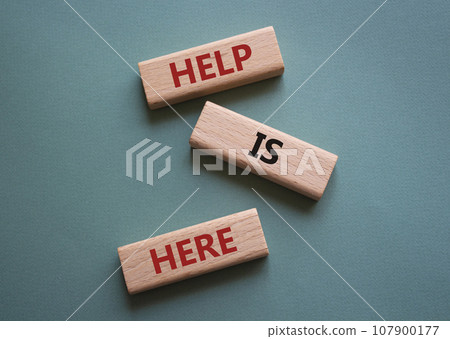 Help is here symbol. Wooden blocks with words Help is here. Beautiful grey green background. Business and Help is here concept. Copy space. Help is here symbol. Wooden blocks with words Help is here. Beautiful grey green background. Business and Help is here concept. Copy space. 107900177