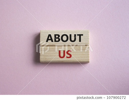 About us symbol. Concept word About us on wooden blocks. Beautiful pink background. Business and About us concept. Copy space 107900272