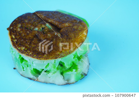 Bikang is a traditional Indonesian cake made with tapioca flour, coconut milk, sugar, and yeast. Bikang is a traditional Indonesian cake made with tapioca flour, coconut milk, sugar, and yeast. 107900647