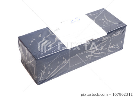 Closed and taped cardboard box Closed and taped cardboard box 107902311