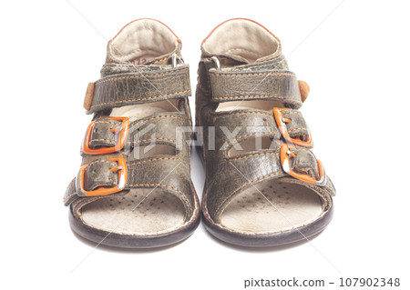 Children's leather sandals isolated on a white background. Children's leather sandals isolated on a white background. 107902348