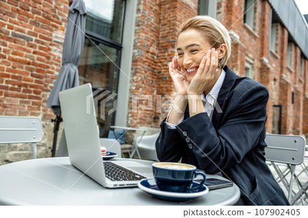 Cute young business woman having a video call Cute young business woman having a video call 107902405