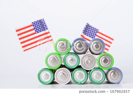 Battery. A lot of batteries on the background of the flag of the country. 107902857