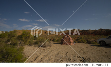A bright starry night in the colored mountains. A bright starry night in the colored mountains. 107903111