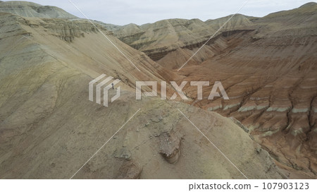 Colorful high mountains and a canyon made of clay Colorful high mountains and a canyon made of clay 107903123