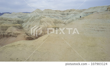 Colorful high mountains and a canyon made of clay Colorful high mountains and a canyon made of clay 107903124