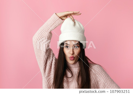 funny woman in white hat, sweater grimacing with lips funny woman in white hat, sweater grimacing with lips 107903251
