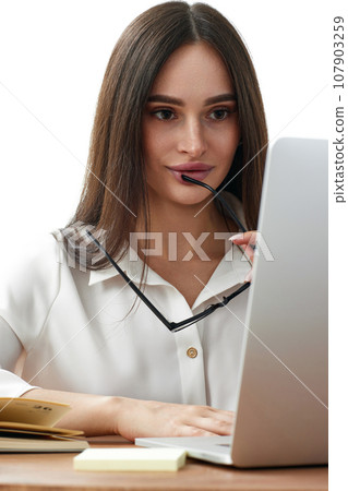 beautiful businesswoman using laptop computer for online work at table 107903259
