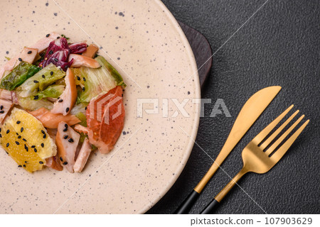 Delicious fresh juicy salad of sliced chicken, grapefruit, lettuce, sesame with olive oil Delicious fresh juicy salad of sliced chicken, grapefruit, lettuce, sesame with olive oil 107903629