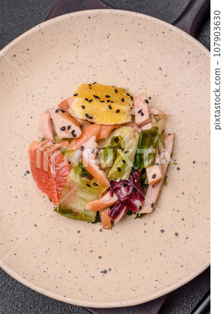 Delicious fresh juicy salad of sliced chicken, grapefruit, lettuce, sesame with olive oil Delicious fresh juicy salad of sliced chicken, grapefruit, lettuce, sesame with olive oil 107903630