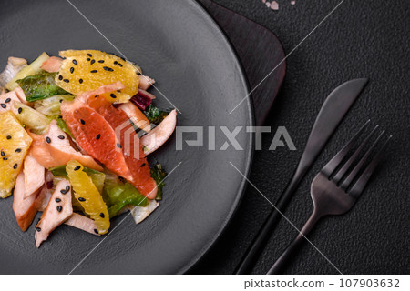 Delicious fresh juicy salad of sliced chicken, grapefruit, lettuce, sesame with olive oil Delicious fresh juicy salad of sliced chicken, grapefruit, lettuce, sesame with olive oil 107903632